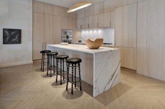 Austin Proper Residence showing Gourmet Kitchen with marble countertops and barstool seating