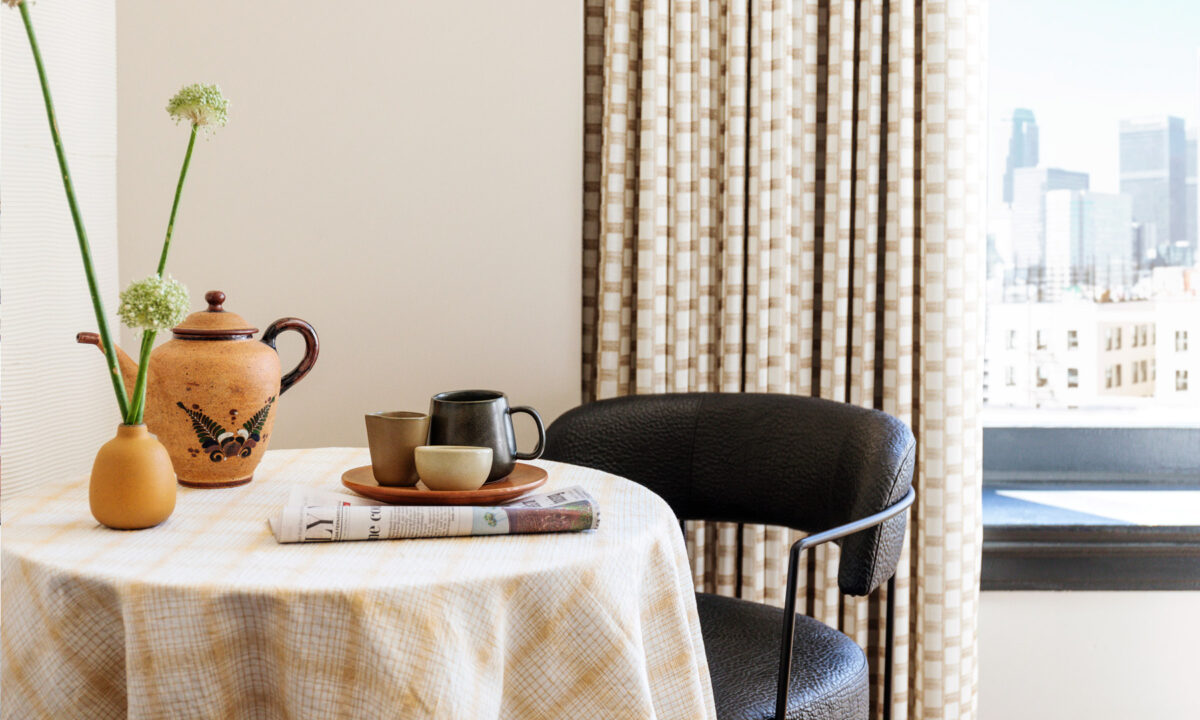 downtown la proper hotel suite seating area with newspaper and coffee
