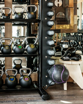 Modern fitness studio with kettlebells, free weights, and strength training equipment