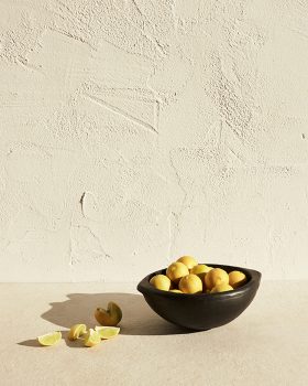 lifestyle image of lemons in a bowl