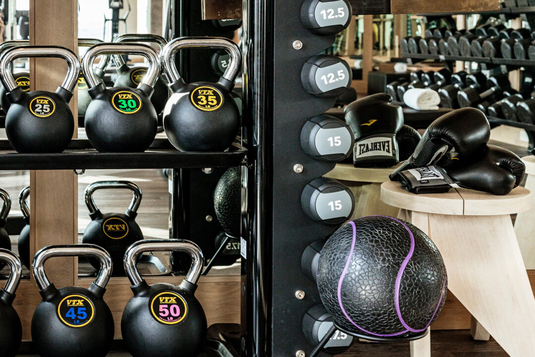 Modern fitness studio with kettlebells, free weights, and strength training equipment
