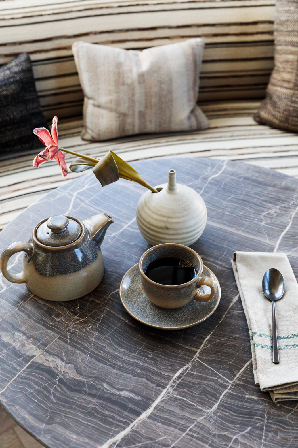 Coffee and ceramic tea set on marble table in a stylish hotel suite lounge area