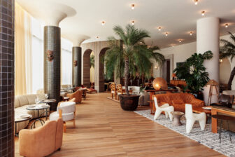 Spacious, sunlit lounge with warm textures and tropical touches.