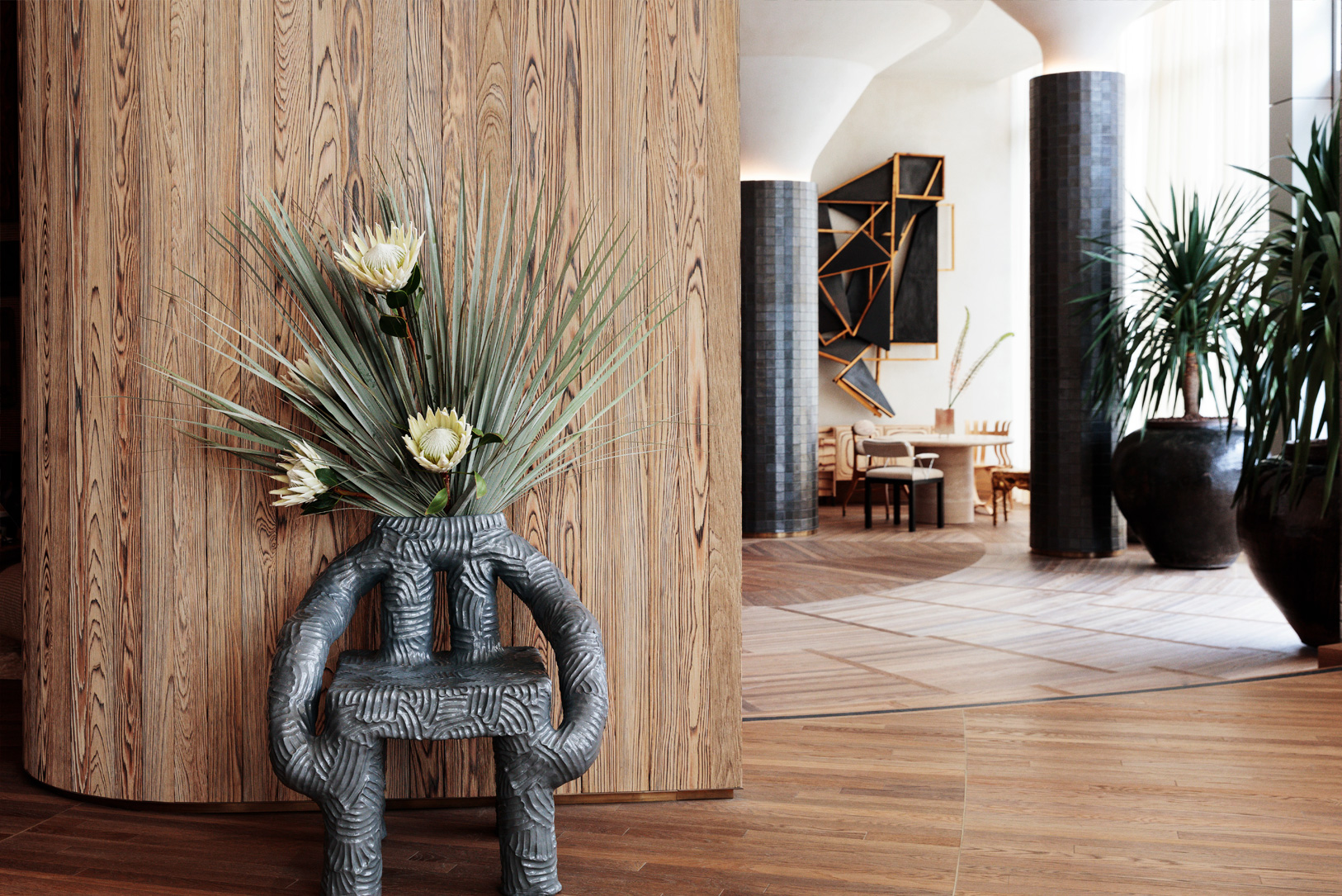 Stylish hotel lobby with sculptural decor and tropical floral arrangement