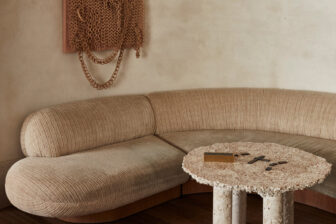 Soft, sculptural lounge with curved seating, neutral tones, and textured design details.