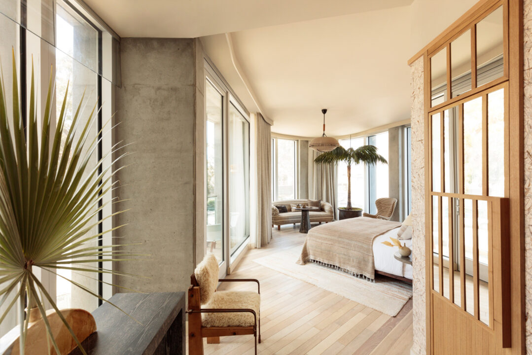 Bright luxury suite with floor-to-ceiling windows and modern coastal interiors