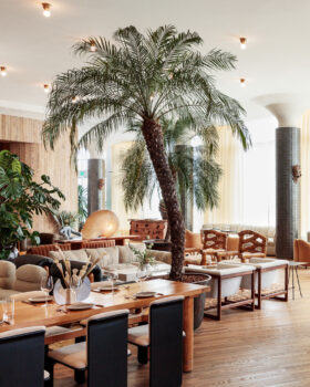 Bright, airy lounge with tropical accents and modern, relaxed seating.