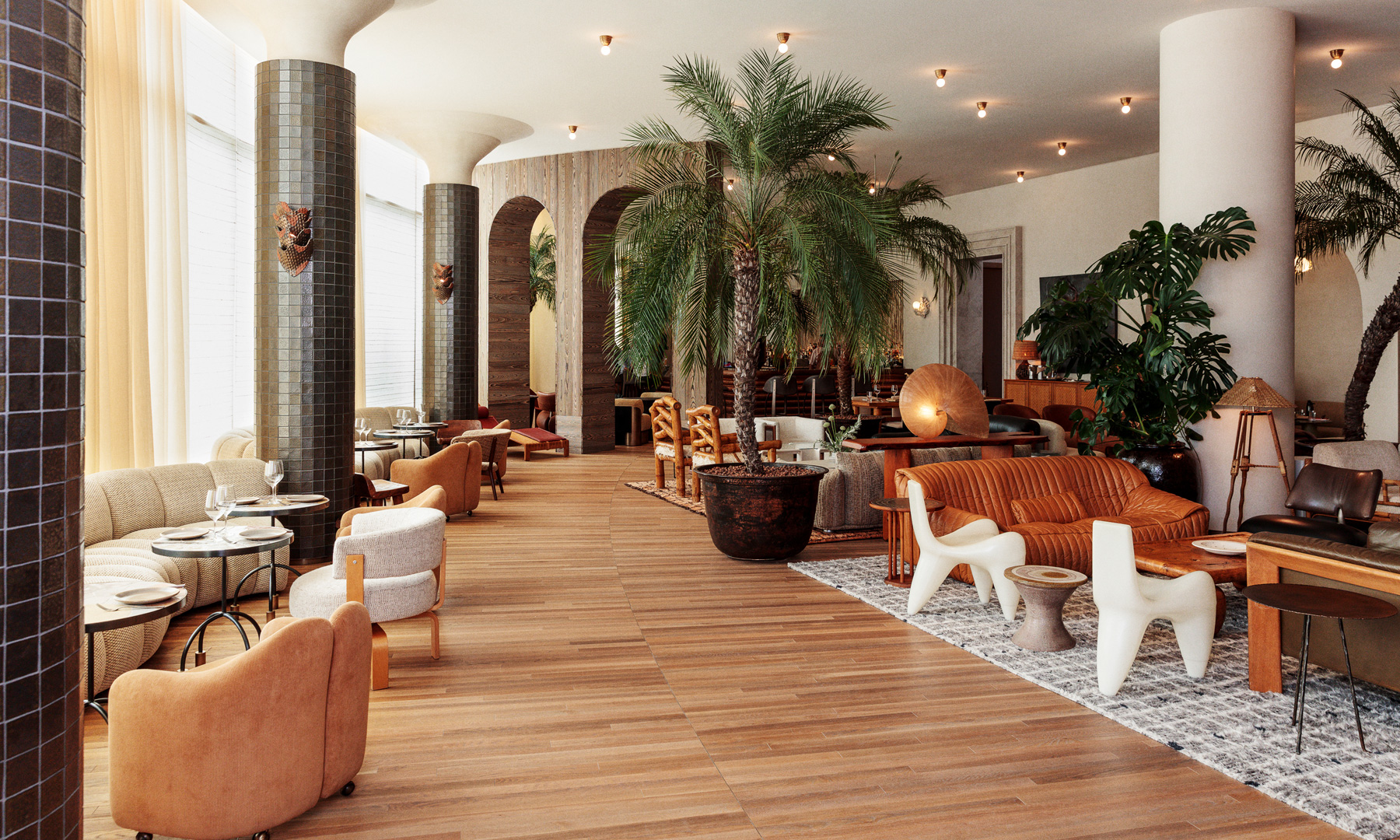 Stylish hotel lounge with palm filled interiors, designer seating, warm wood tones, and upscale dining ambiance