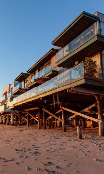 Exterior image of malibu beach house during day time with view of huge outdoor terrace