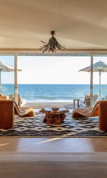 Malibu Beach House living space with two chairs facing beach front terrace