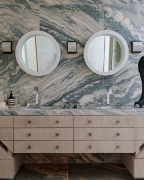 Malibu Beach House large bathroom with double vanity and marble walls