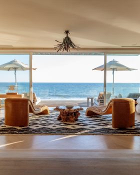 Malibu Beach House living space with two chairs facing beach front terrace