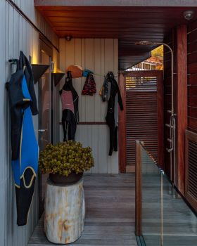 Outdoor shower with wet suits hanging