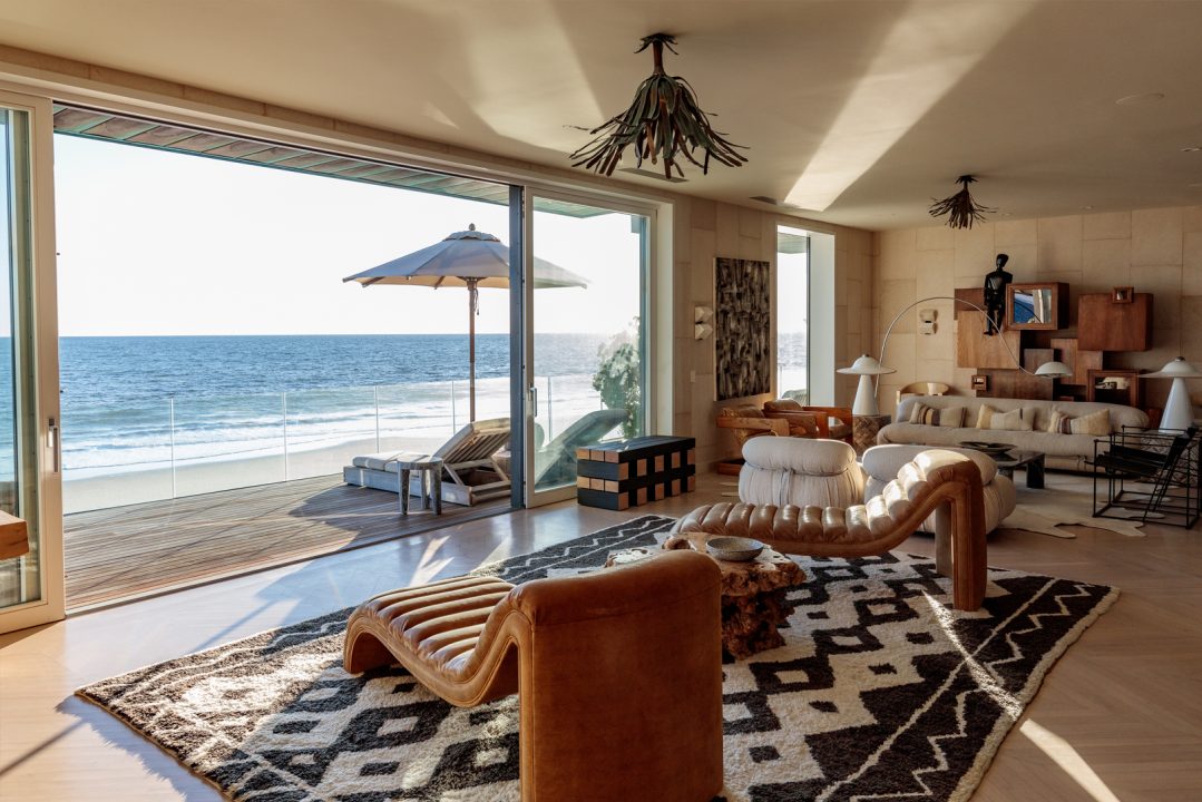 Malibu Beach House living space with two chairs facing beach front terrace