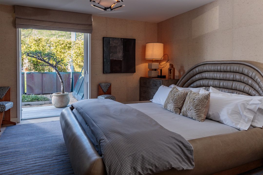 Malibu beach house bedroom with king sized bed and kelly wearstler custom designs
