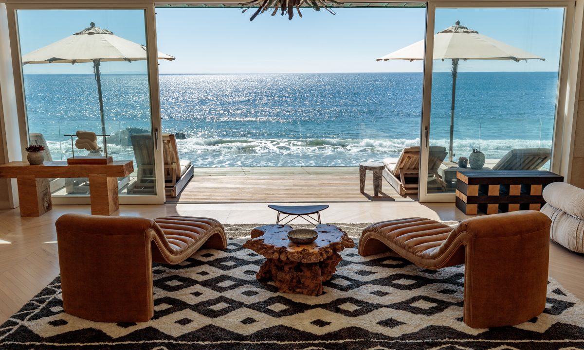 Malibu Beach House living space with two chairs facing beach front terrace