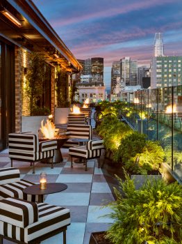 charmaines outdoor rooftop at night with fire pits