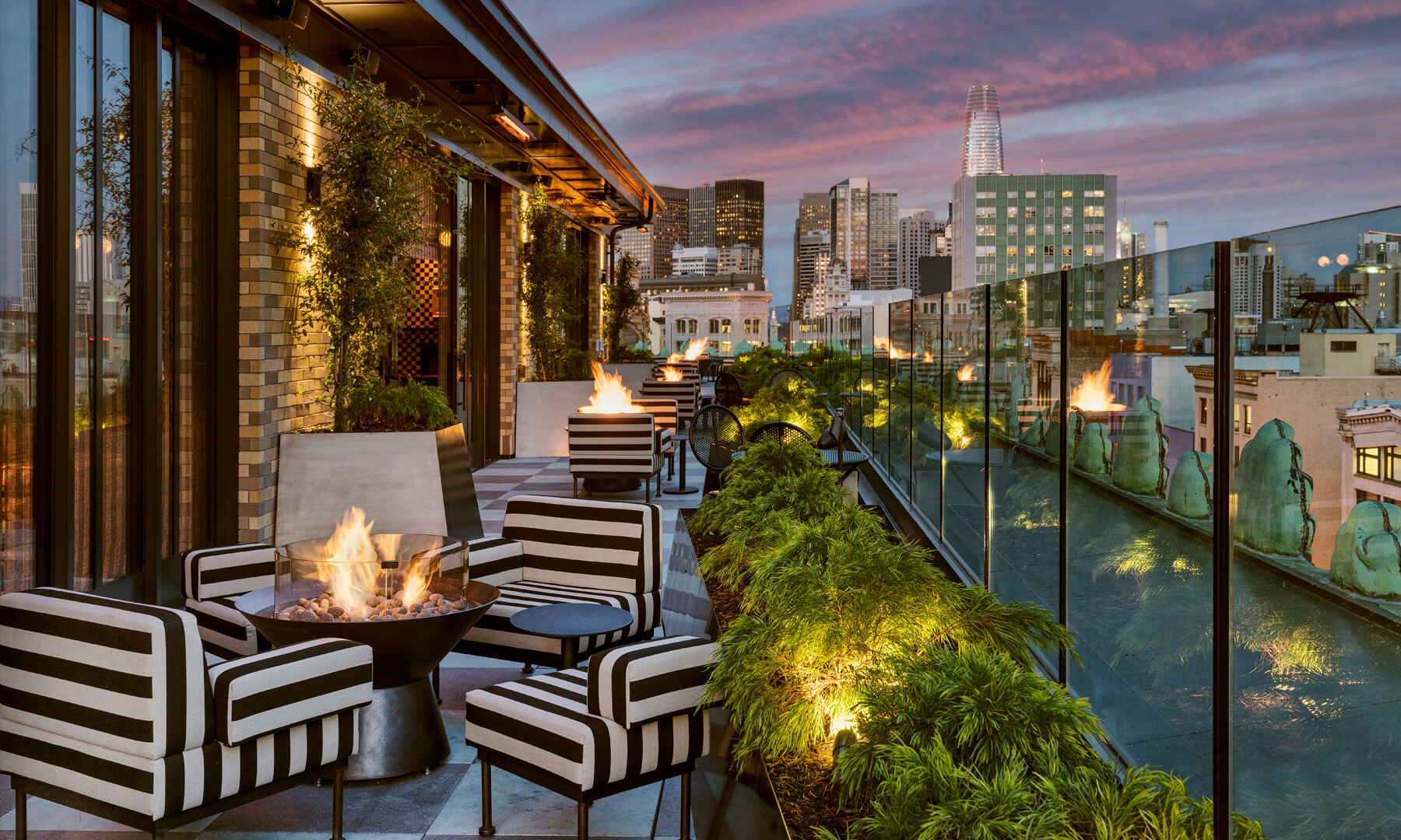 Charmaine's Rooftop Bar & Lounge night view with sunset and city skyline