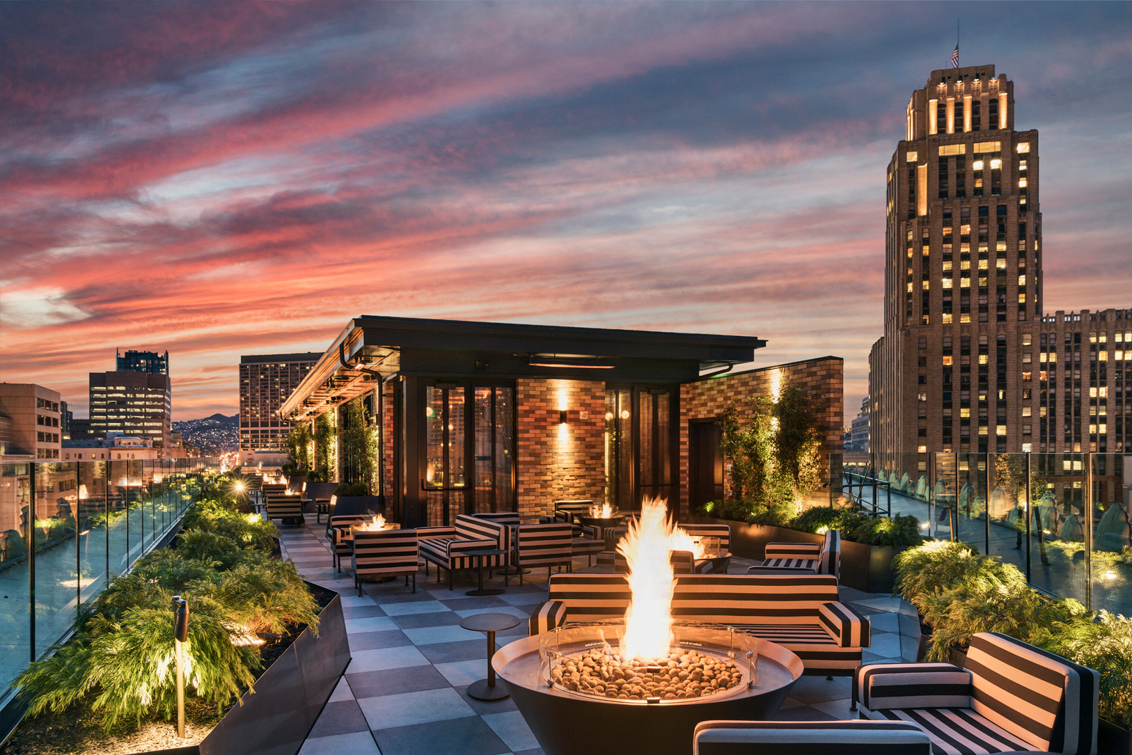 Charmaine's Rooftop at night with city skyline