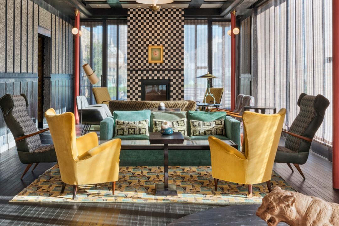 Elegant rooftop lounge with designer seating and fireplace centerpiece