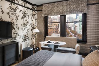 Elegant guest room with city views and patterned designer interiors