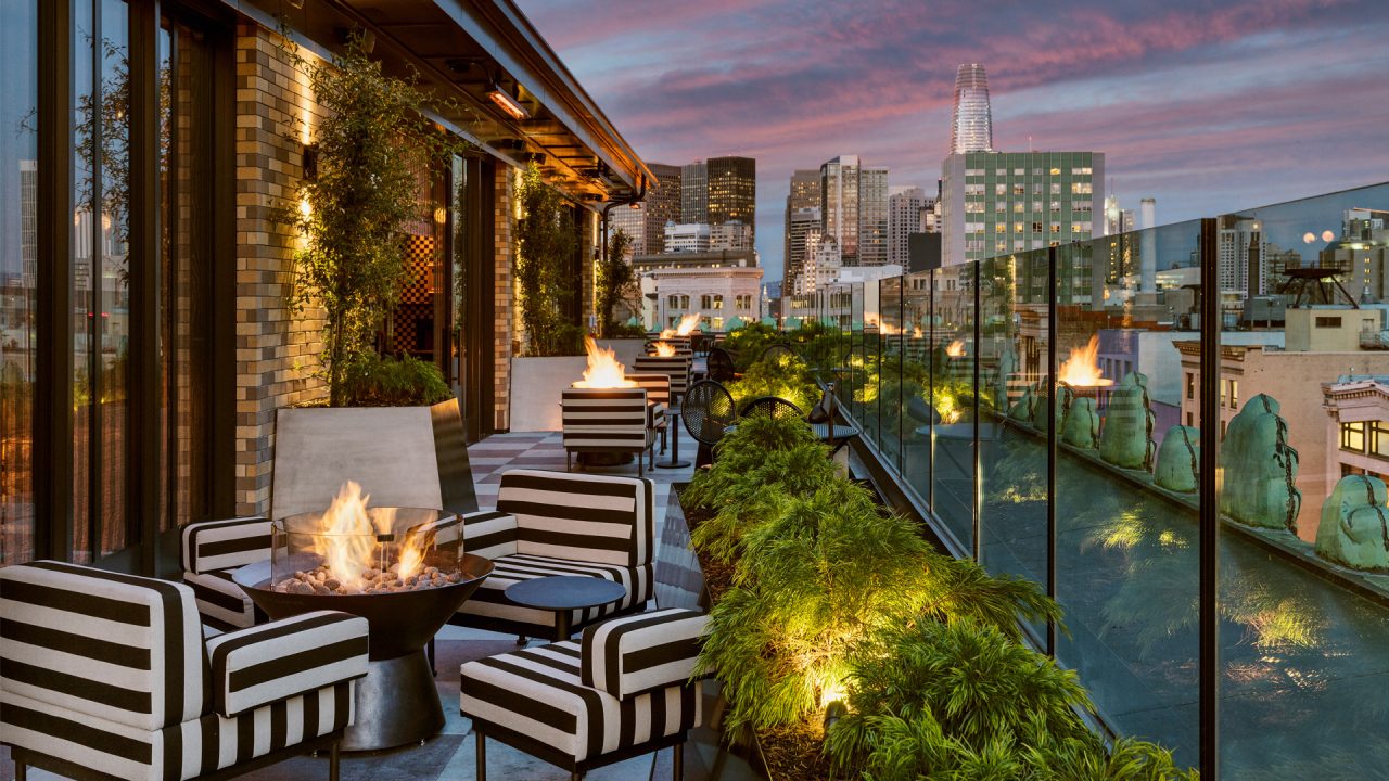 Charmaine's Rooftop Bar & Lounge at night with skyline view