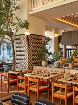Bright and stylish dining space with lush greenery, artisan details, and contemporary California inspired design