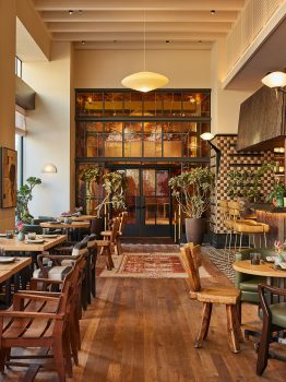 Warm, stylish restaurant with natural light and inviting wood accents.