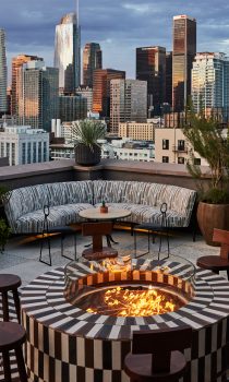 Cara Cara rooftop restaurant with fire pit, couches and view of city sky line