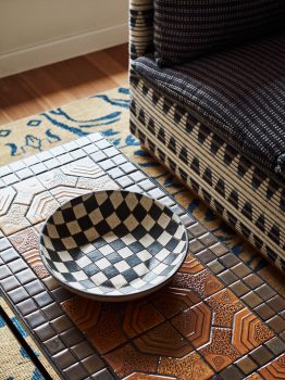 Close up shot of checkered antique bowl in guest room