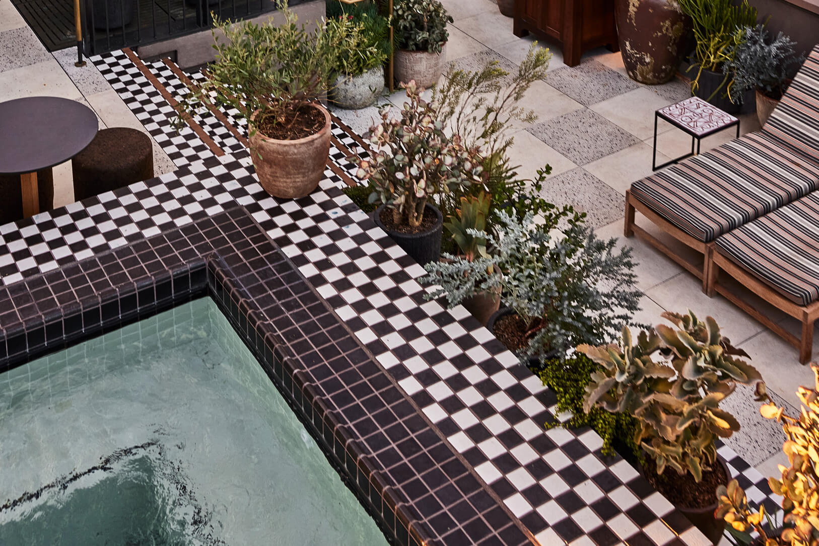 Downtown LA Proper Pool with tiled floors and loungechairs