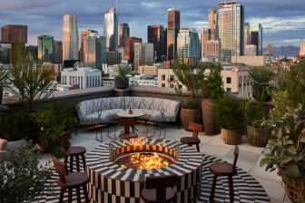 Cara Cara rooftop restaurant with fire pit, couches and view of city sky line