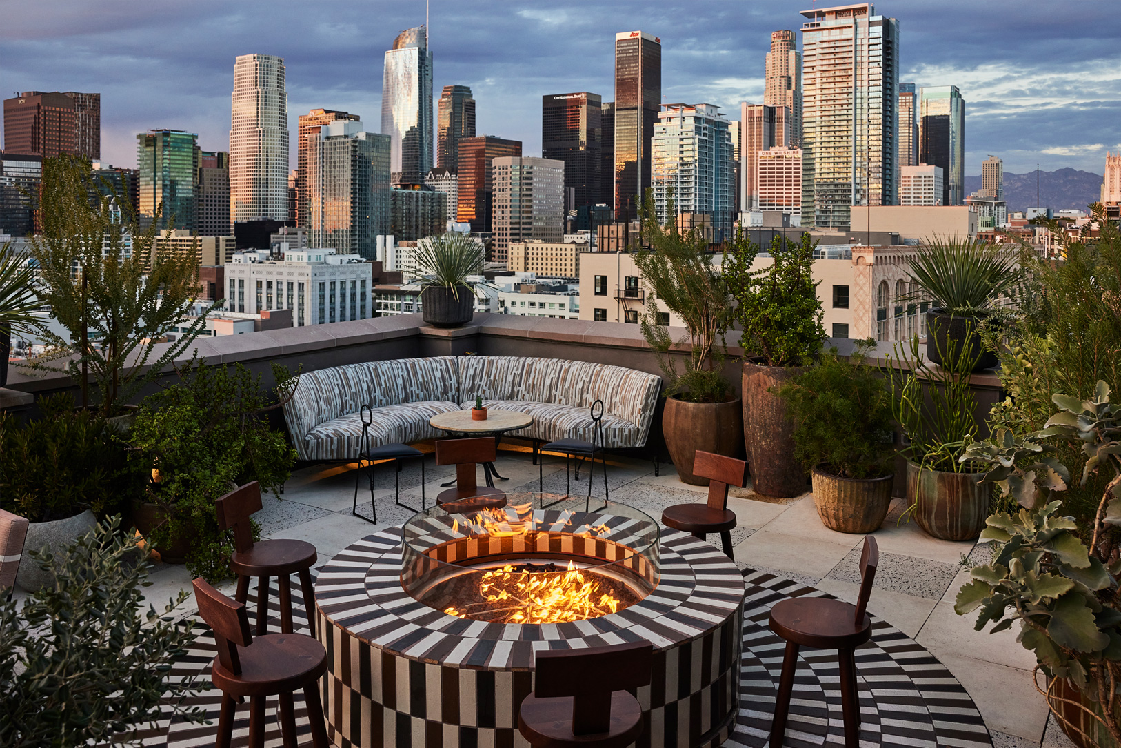 Cara Cara rooftop restaurant with fire pit, couches and view of city sky line