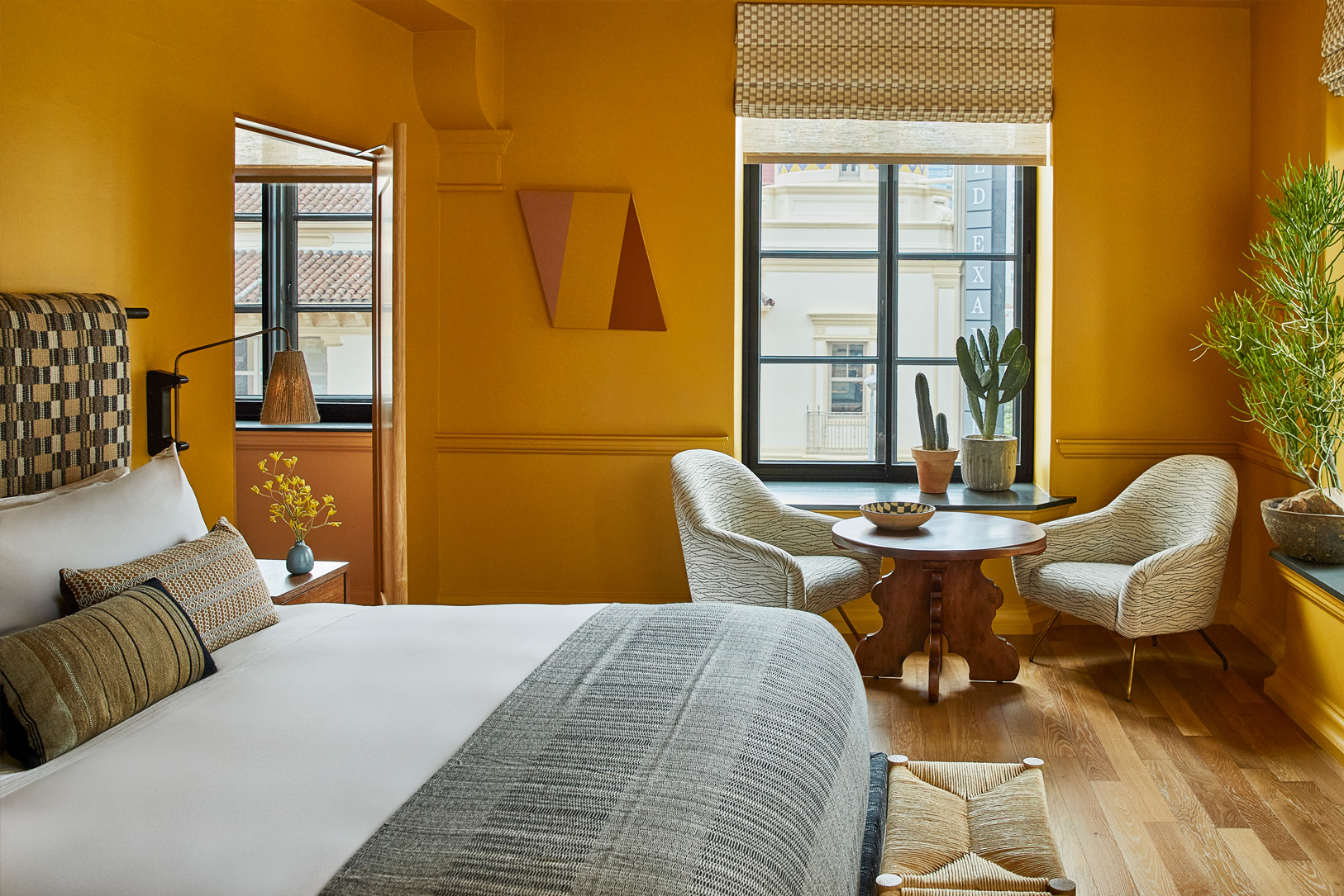 Warm and inviting guest room with custom furnishings, natural light, and modern Downtown LA design details
