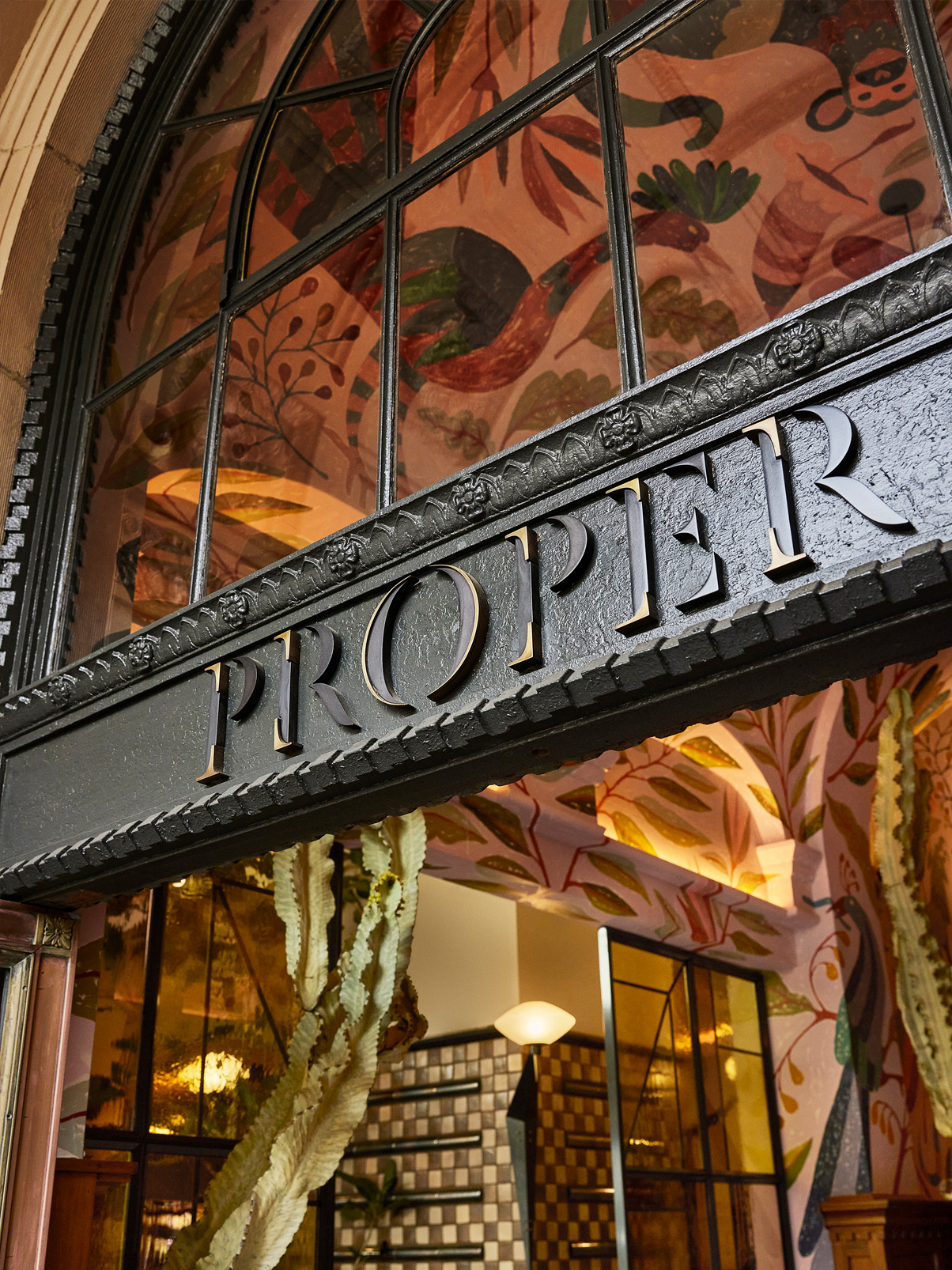 Close-up of Proper Hotel signage above an ornate entrance