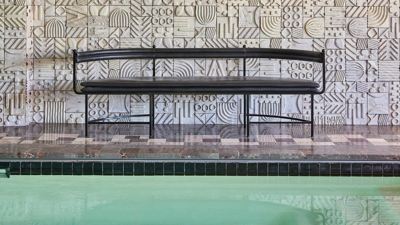 Indoor swimming pool with seating area inside pool suite