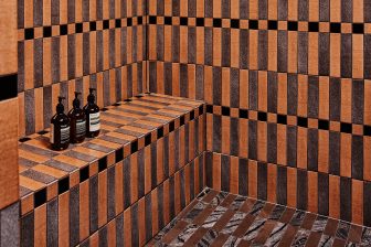 Designer tiled shower with geometric patterns and premium bath amenities