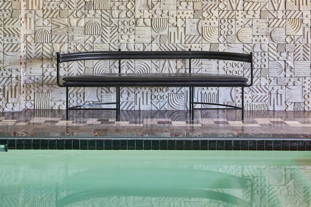 Indoor swimming pool with seating area inside pool suite