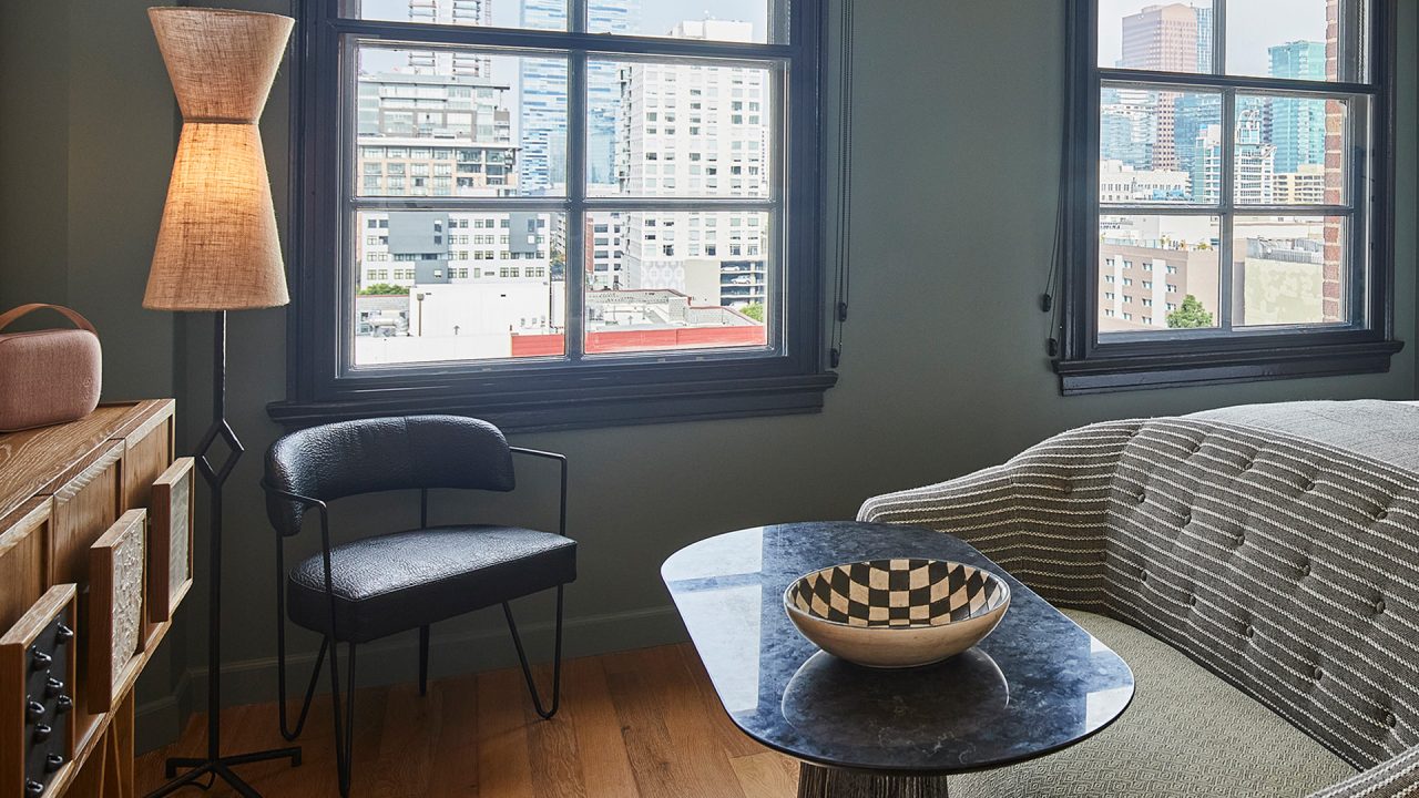 Cozy seating area with city views, modern furnishings, and warm ambient lighting