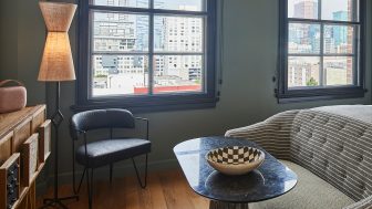 Cozy seating area with city views, modern furnishings, and warm ambient lighting