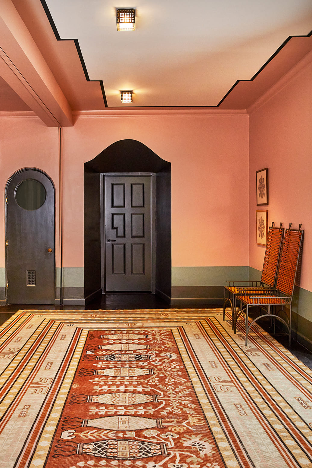 Elegant foyer with patterned rug and blush walls