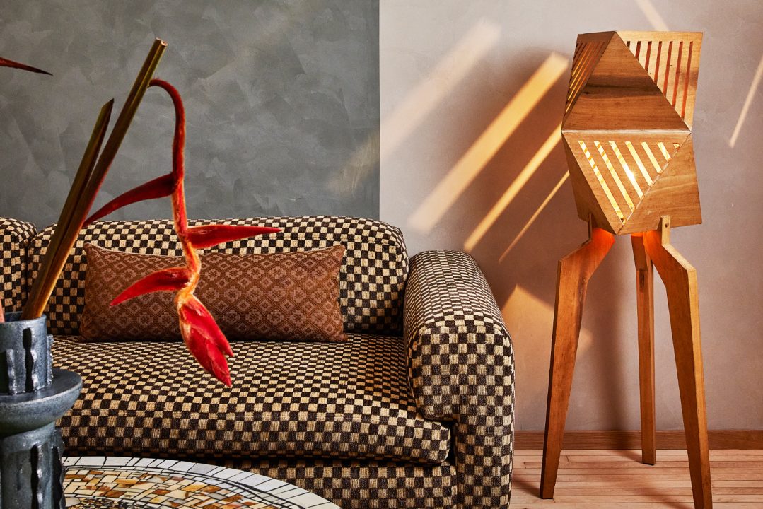 Modern lounge seating with patterned sofa, sculptural lighting, and warm designer details in a Downtown LA suite
