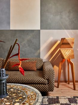 Modern lounge seating with patterned sofa, sculptural lighting, and warm designer details in a Downtown LA suite