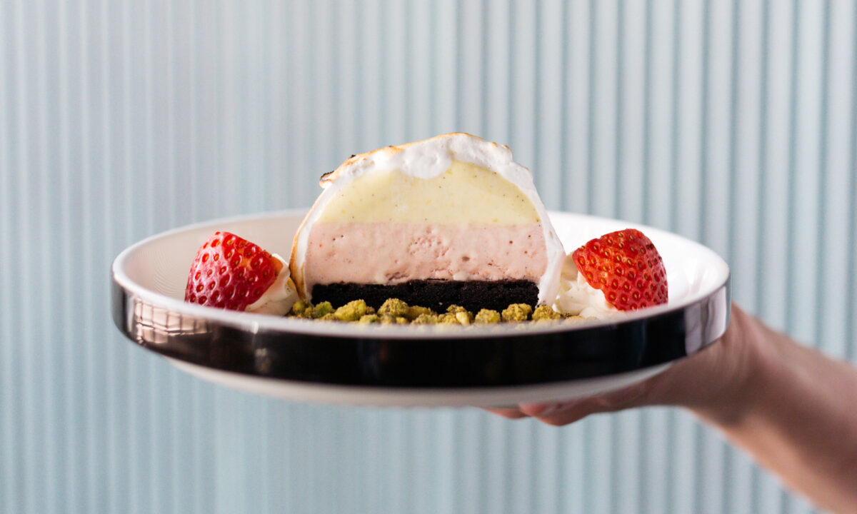 Elegant plated dessert with fresh strawberries and artisanal presentation