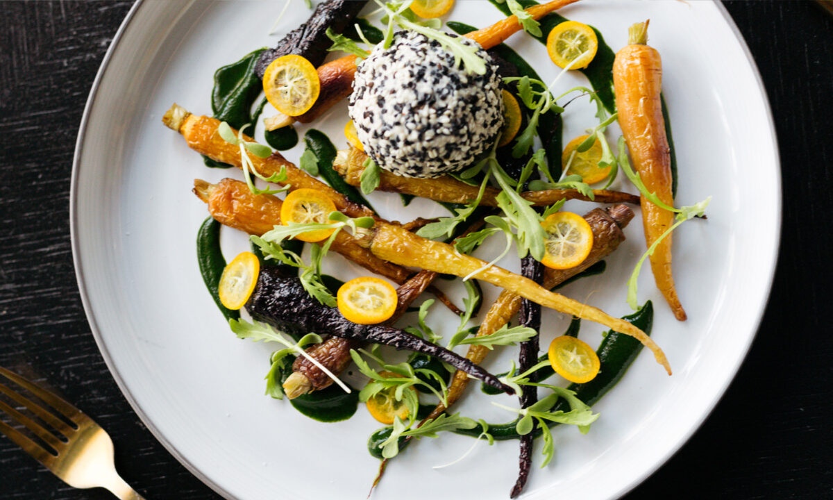 Seasonal gourmet dish with roasted vegetables and elegant fine dining presentation