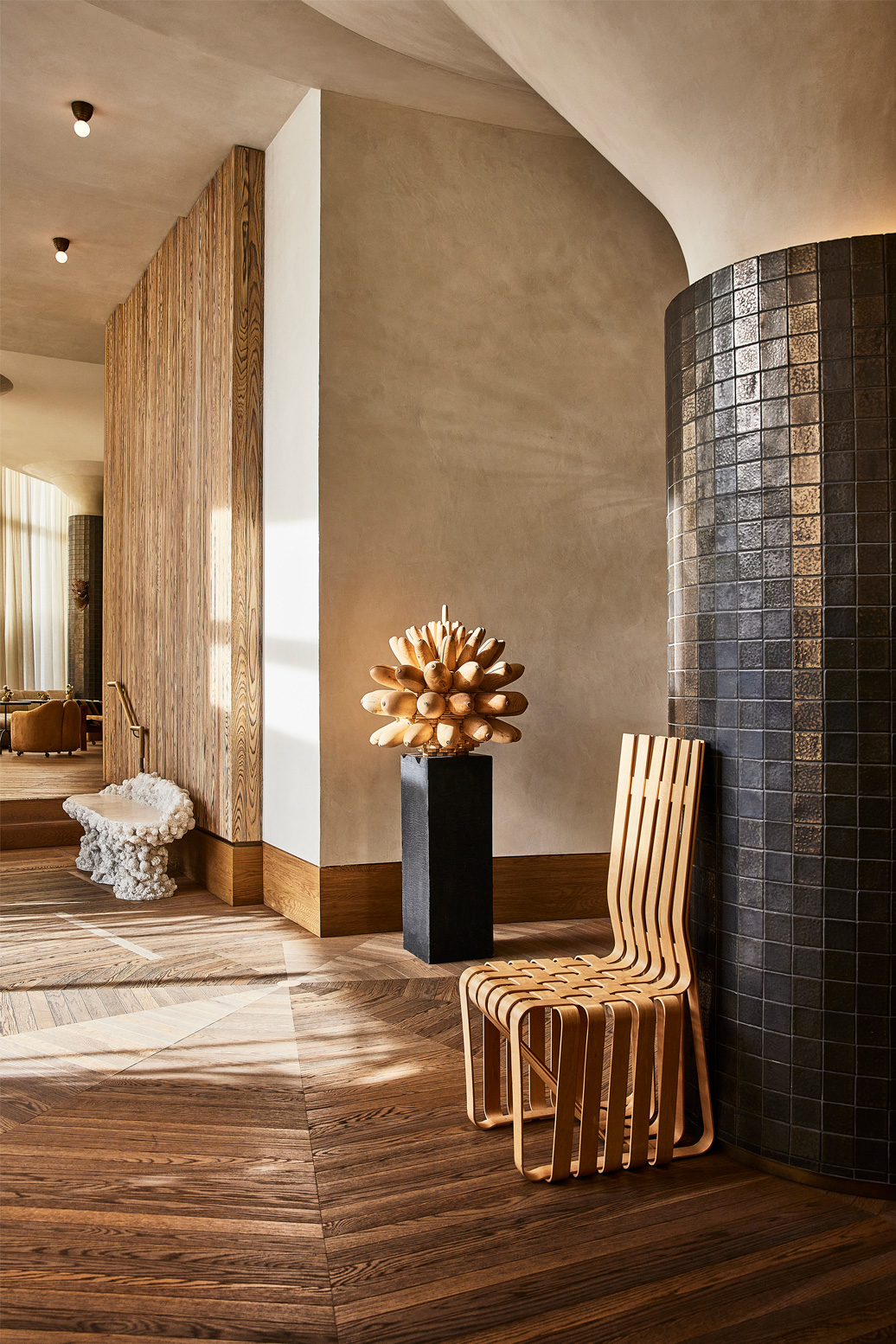 Modern hotel interior with sculptural chair and warm wood accents