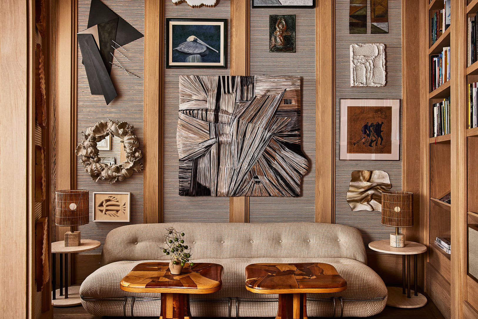 Art filled luxury hotel lounge with curated decor, sculptural furniture, and warm wood interiors