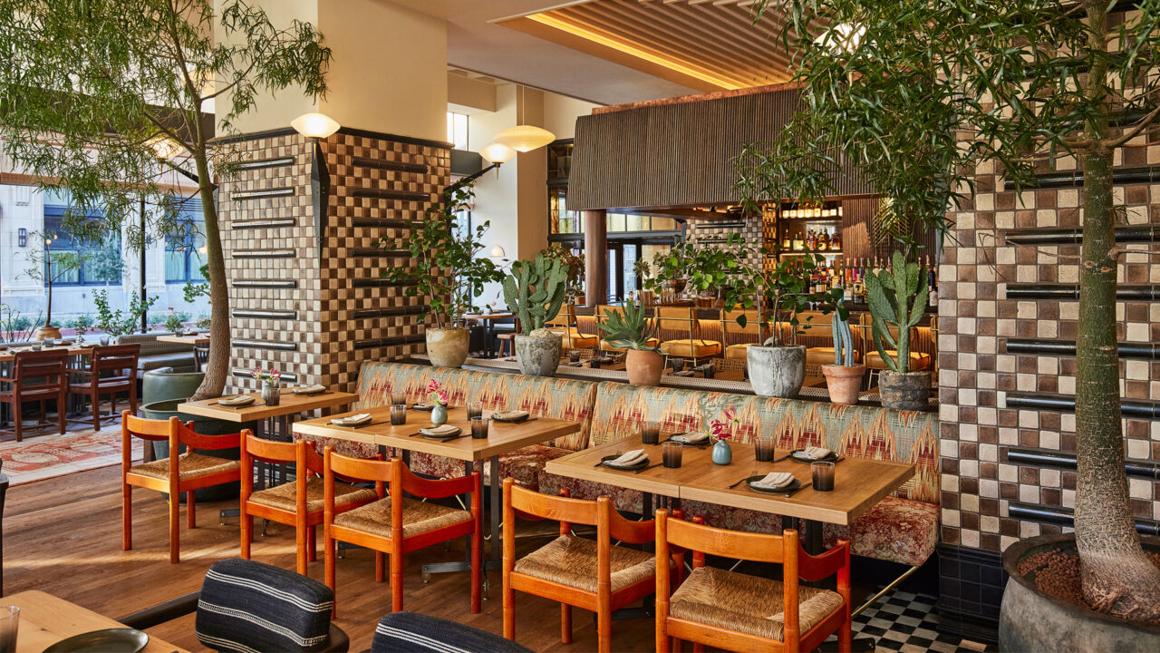 Stylish restaurant interior with lush greenery, artisan tilework, and warm contemporary dining ambiance in Downtown LA