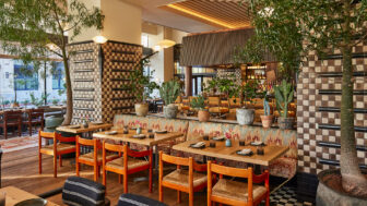 Stylish restaurant interior with lush greenery, artisan tilework, and warm contemporary dining ambiance in Downtown LA