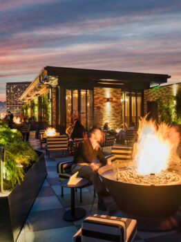 Charmaine's rooftop with guests enjoying drinks at the firepit